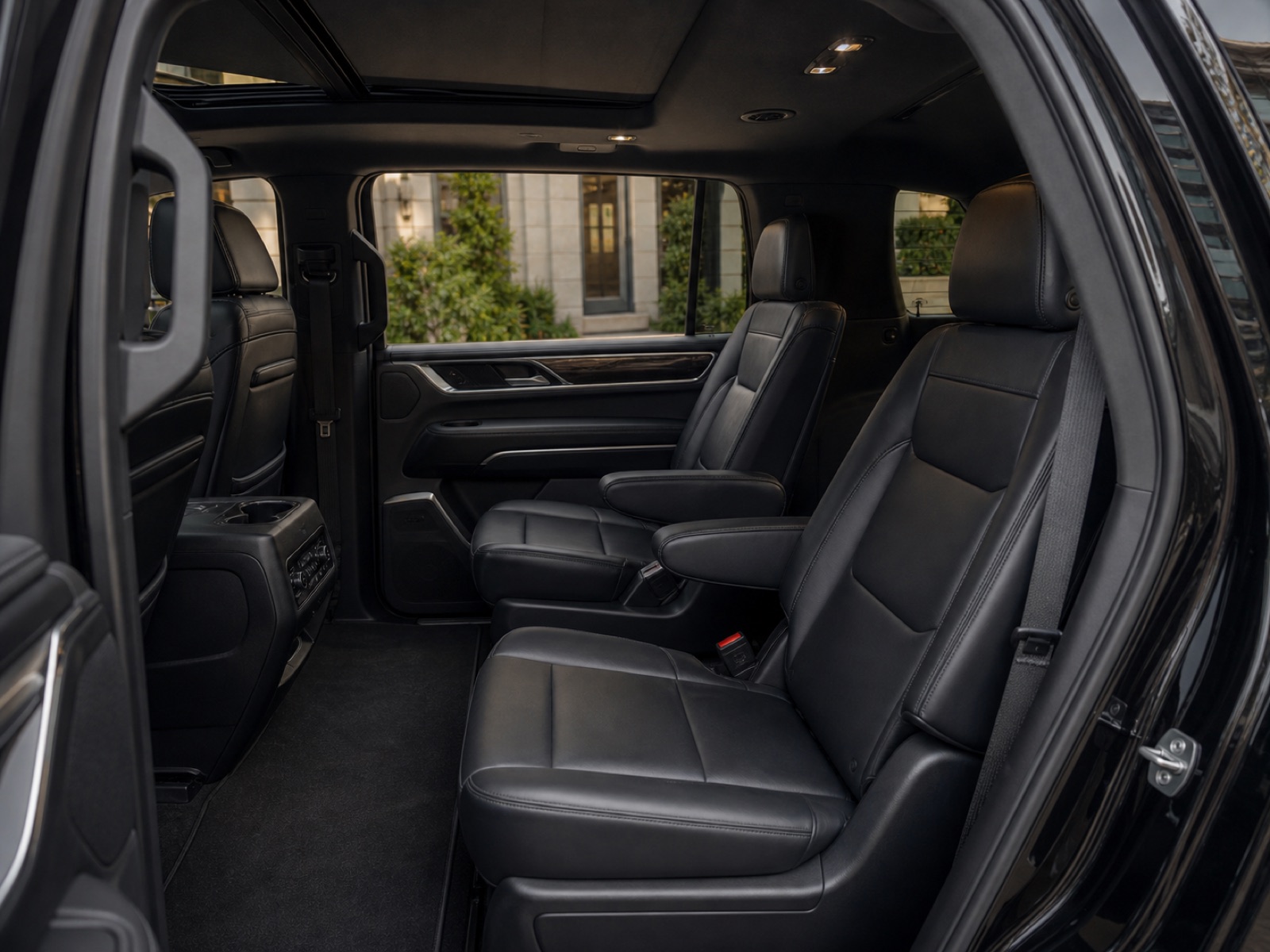 Black leather captain chairs in a Cadillac Escalade SUV