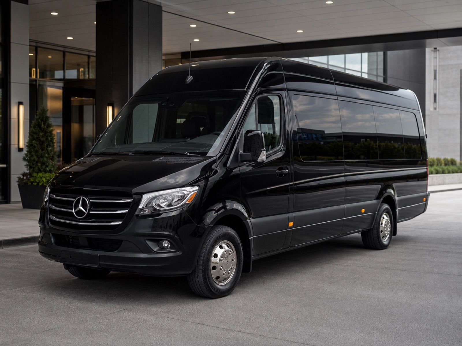 Black Mercedes Sprinter executive van at a private terminal